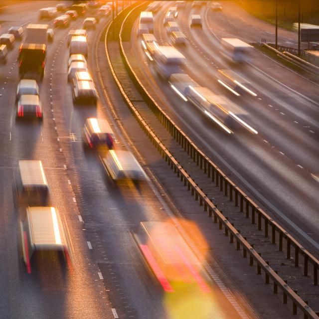 Rush hour traffic on the M60 motorway near Manchester at sunset, UK.