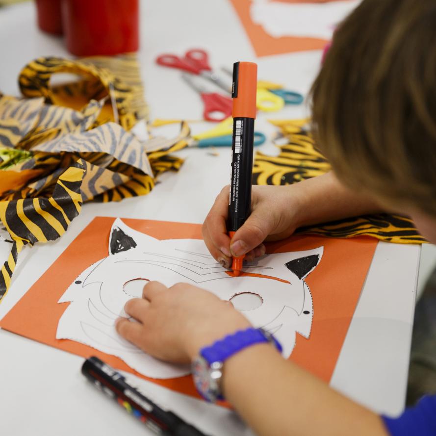 Pupil creating a tiger mask at a LPC workshop event