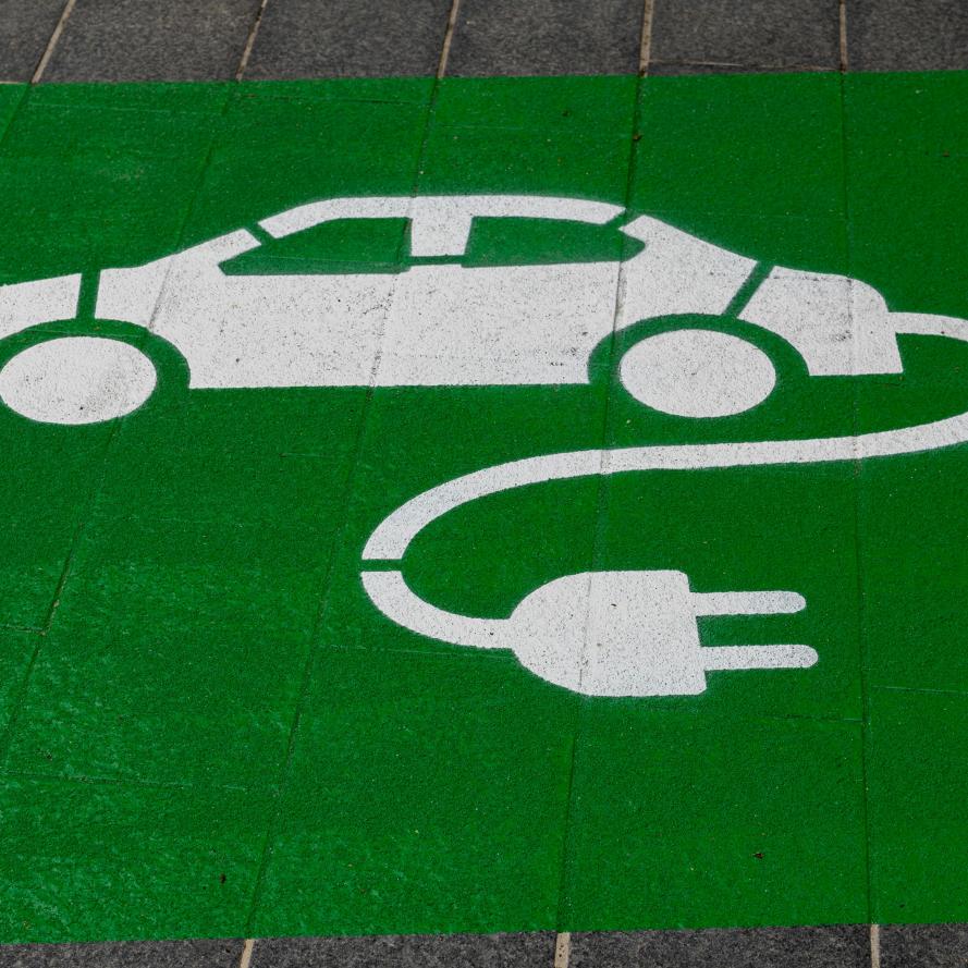 Green ground charging signage on parking bay
