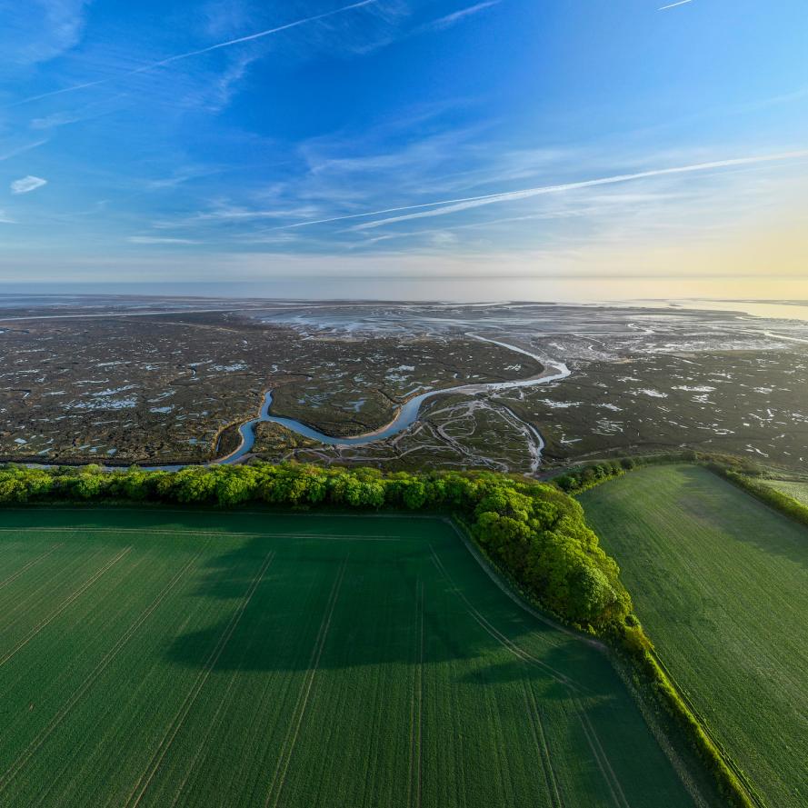 Drone shot of Stiffkey Marshes as tide comes in looking out to ocean. Stiffkey Marshes, Stiffkey, North Norfolk, UK.