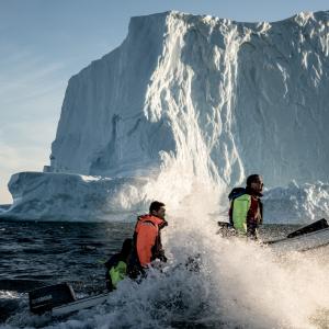Boat in the Arctic in front of iceberg