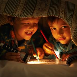 Children drawing by torchlight
