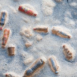 Plastic rubbish bottles floating in a dock in middlesbrough, Teeside, UK, in foam