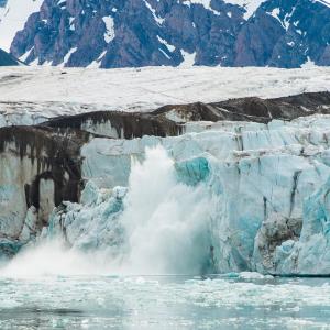 A glacier calving into the ocean