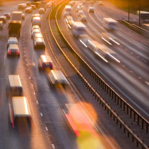 Rush hour traffic on the M60 motorway near Manchester at sunset, UK.