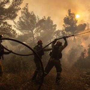 Firefighters battle a wildfire in Agia Sotira, a western suberb of Athens, Greece, on July 20, 2023.
