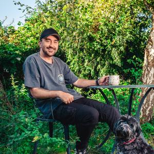 Conor McDonnell and his dog having a cup of tea in the garden