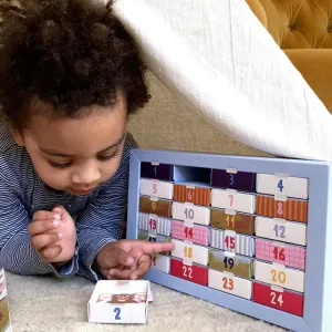 Child next to PLAYin CHOC - Advent Calendar