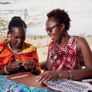 Resian Letoluo (red top/ sunglasses), Maa Trust, Beadwork Manager, Kenya.