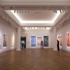 A large room with various artworks hung on the wall