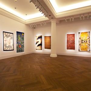 A large room with various artworks hung on the wall