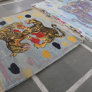The fabrication of two rugs laid on the floor