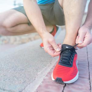 Man tying shoe lace