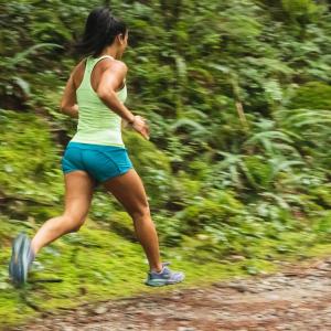 female runner on trail in the forest
