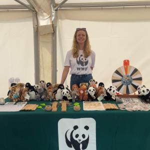 Woman stood at WWF stall, smiling