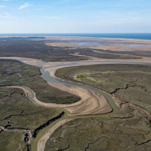 Drone shot of Stiffkey Marshes as tide comes in. Stiffkey Marshes, Stiffkey, North Norfolk, UK.